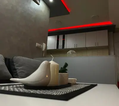 a table with a candle on top of a kitchen counter at GM Apartman Obrenovac in Obrenovac