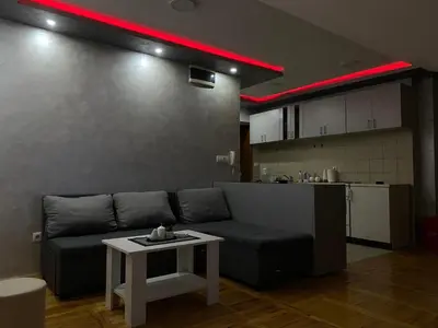 a living room with a couch and a table at GM Apartman Obrenovac in Obrenovac
