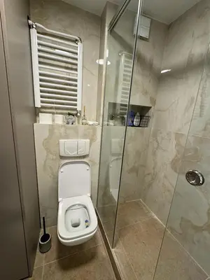a bathroom with a toilet and a glass shower at Arena Mila in Novi Beograd