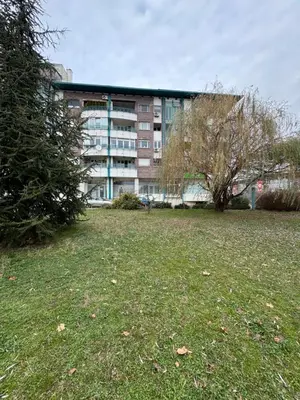 a building with a grass field in front of a building at Arena Mila in Novi Beograd
