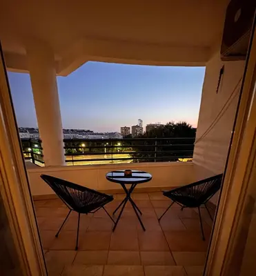 a balcony with a table and chairs and a view at Arena Mila in Novi Beograd