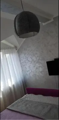 a bedroom with a bed and a ceiling at Lux Apartments With Pool Dex in Zemun Polje