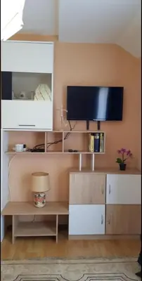 a living room with a tv on a wall at Lux Apartments With Pool Dex in Zemun Polje