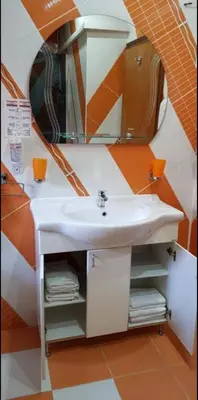 a bathroom with a sink and a mirror at Lux Apartments With Pool Dex in Zemun Polje