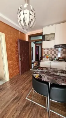 a kitchen with a table and chairs in a room at Lux Apartments With Pool Dex in Zemun Polje