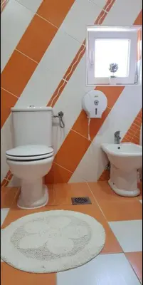a bathroom with a toilet and a sink at Lux Apartments With Pool Dex in Zemun Polje