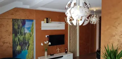 a living room with a chandelier and a tv at Lux Apartments With Pool Dex in Zemun Polje