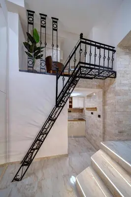 a black spiral staircase in a room at Apartment Kaliopi in Belgrade