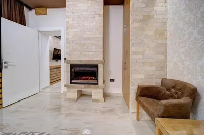 a living room with a couch and a fireplace at Apartment Kaliopi in Belgrade
