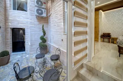 a living room with three chairs and a fireplace at Apartment Kaliopi in Belgrade