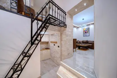 a spiral staircase in a room with a living room at Apartment Kaliopi in Belgrade