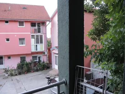 a view from a balcony of a pink building at Apartments 43 in Krnjača