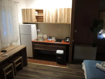 a small kitchen with a sink and a refrigerator at Apartments 43 in Krnjača