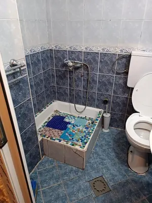a bathroom with a shower with blue tiles at Maravilja 7 in Belgrade