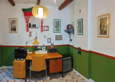 a kitchen with green and white walls and a table and chairs at Kuća za odmor u Banatu in Debeljača