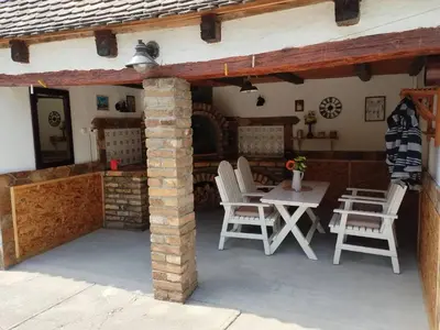 a patio with chairs and a table in a house at Kuća za odmor u Banatu in Debeljača