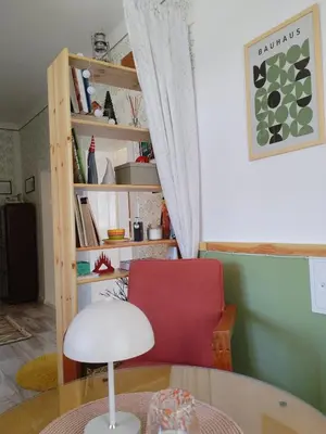 a living room with a red chair and a table at Kuća za odmor u Banatu in Debeljača