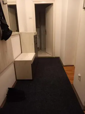 an empty room with a bench and a hallway at Nikola Hram in Belgrade