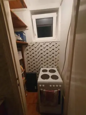 a small stove in a small kitchen with a window at Nikola Hram in Belgrade