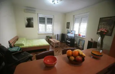 a living room with a table with fruit on it at Studio Tash in Belgrade