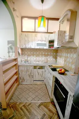 a kitchen with white cabinets and a sink and a counter at Studio Tash in Belgrade