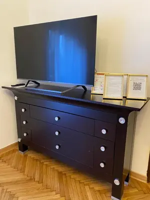 a black dresser with two books on top of it at Apartment Washington in Belgrade