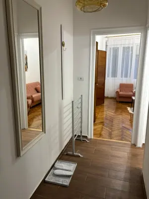 a hallway with a mirror and a floor at Apartment Washington in Belgrade