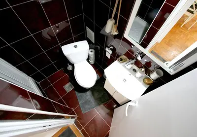a small bathroom with a toilet and a sink at Dali Arena Business Comfort Apartment 2 Bedrooms King Size in Belgrade