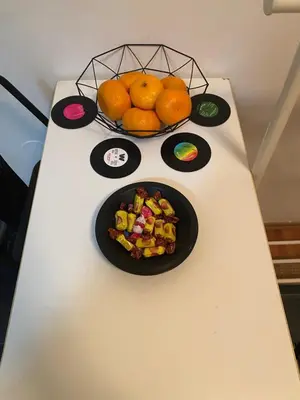 a table with a bowl of fruit and a bowl of oranges at Shine DISCO room in Belgrade