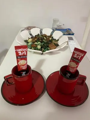 two red cups on a table with a plate of food at Shine DISCO room in Belgrade
