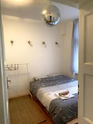 a small bedroom with a bed in a room at Shine DISCO room in Belgrade