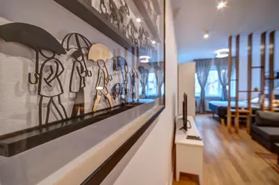 a room with a wall with a painting of people on it at Miss Sunshine 4* in Belgrade