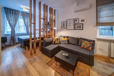 a living room with a couch and a bed at Miss Sunshine 4* in Belgrade