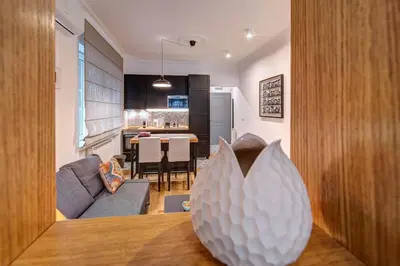 a living room and kitchen with a couch and a table at Miss Sunshine 4* in Belgrade