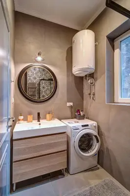 a bathroom with a washing machine and a sink at Miss Sunshine 4* in Belgrade