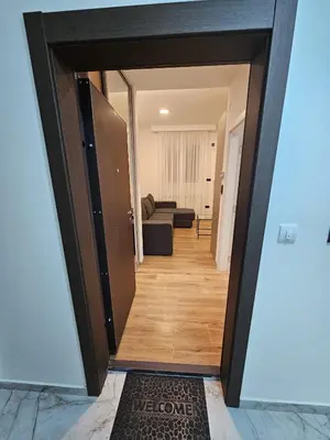 a hallway with a door open to a living room at Anchy in Belgrade