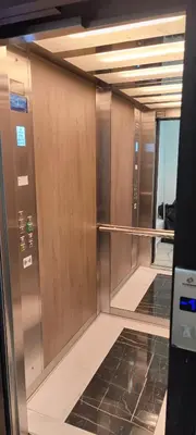 an empty elevator lobby with mirrored doors in a building at Anchy in Belgrade