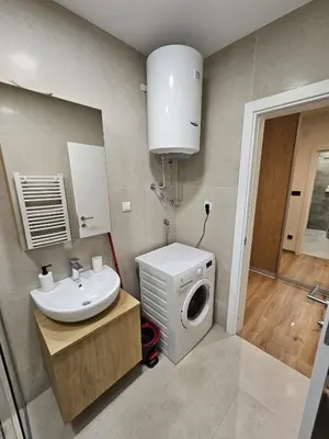 a bathroom with a washing machine and a washer at Anchy in Belgrade