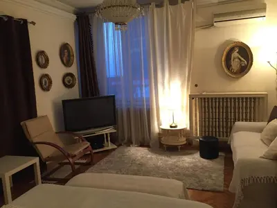 a living room with a couch and a television at Apartment Baroque in Belgrade