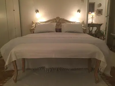 a bedroom with a large bed with a white bedspread at Apartment Baroque in Belgrade