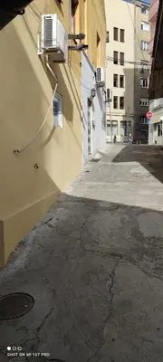 an empty alley with a building with an air conditioner at Gallery in Belgrade