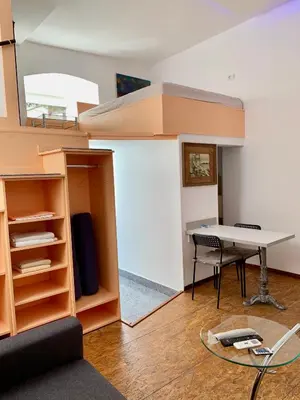 a living room with a desk and a table at Gallery in Belgrade
