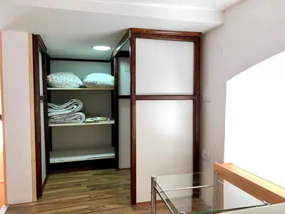 a room with a glass table and a closet at Gallery in Belgrade