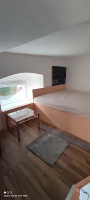 a bedroom with a bed and a coffee table at Gallery in Belgrade