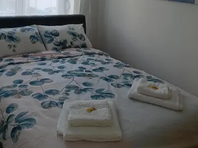 a bed with two towels on top of it at Tera apartment Zemun in Belgrade