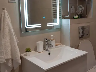 a bathroom with a sink and a mirror at Tera apartment Zemun in Belgrade