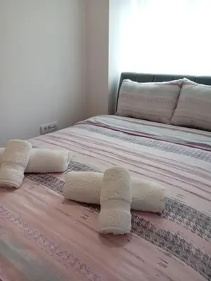 a bedroom with two beds with towels on the floor at Tera apartment Zemun in Belgrade