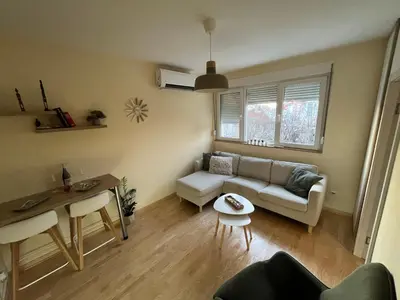 a living room with a couch and a table at My Pier in Bele Vode