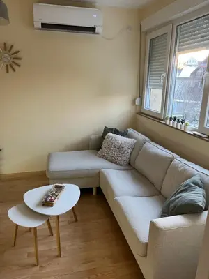 a living room with a couch and a table at My Pier in Bele Vode