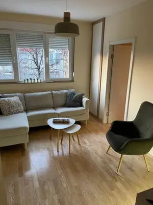 a living room with a couch and a table at My Pier in Bele Vode